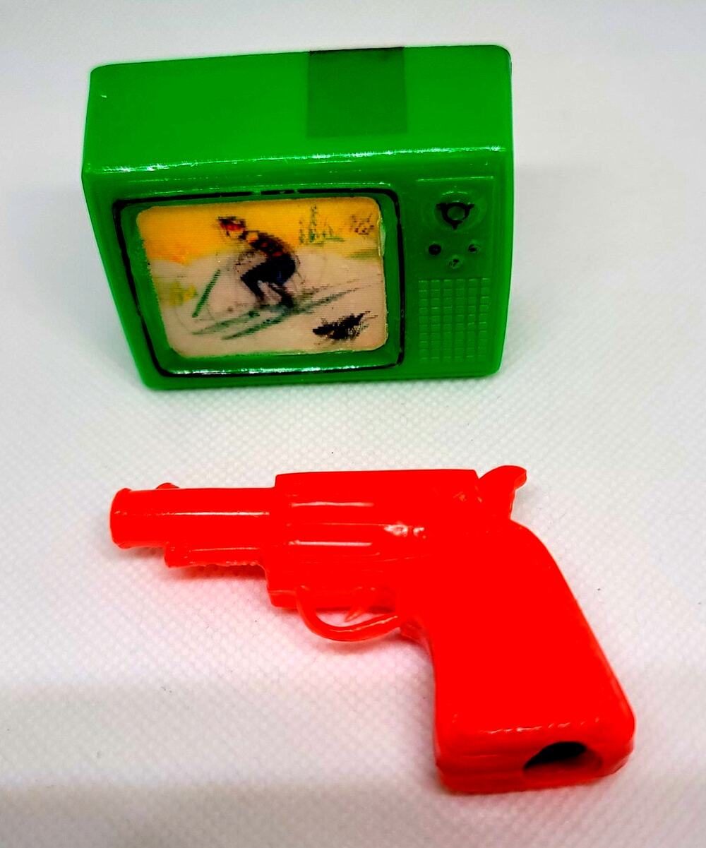 Two 1950's Plastic Toy Pencil Sharpeners Red Western Revolver Green "Wiggle TV"